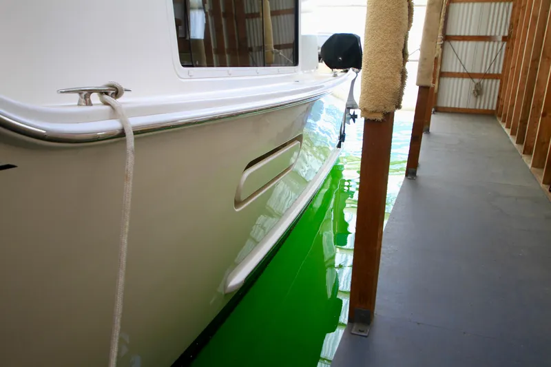 Slide: The Image of 2011 Fathom Element 43 boat docked in a covered marina. - 7