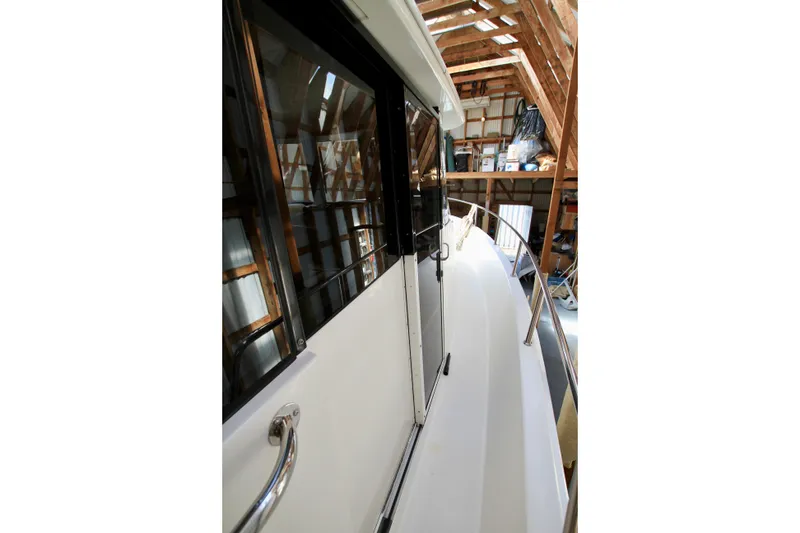 Slide: The Image of 2011 Fathom Element 43 yacht in storage, showcasing sleek design and polished railings. - 73