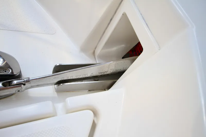Slide: The Image of Anchor compartment of 2011 Fathom Element 43 boat, featuring stainless steel anchor. - 77