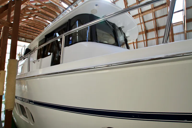 Slide: The Image of 2011 Fathom Element 43 yacht in a wooden boathouse, showcasing sleek design and windows. - 8