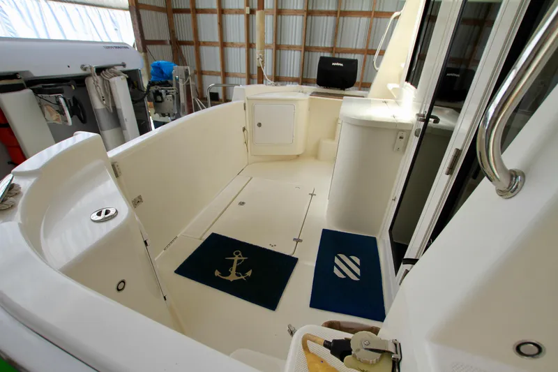 Slide: The Image of Interior view of 2011 Fathom Element 43 boat, featuring spacious deck and nautical decor. - 9