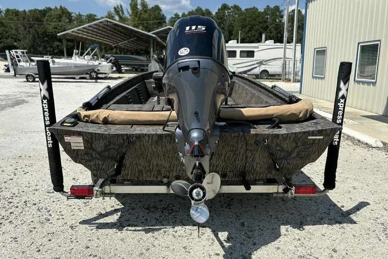 Slide: The Image of 2024 Xpress XP200 Catfish boat with powerful outboard motor, parked outdoors. - 10
