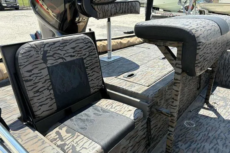 Slide: The Image of 2024 Xpress XP200 Catfish boat interior with camouflage seating and Yamaha 115 engine. - 2
