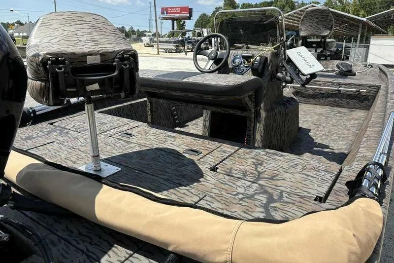 Slide: The Image of 2024 Xpress XP200 Catfish boat interior with camouflage seating and advanced navigation equipment. - 3