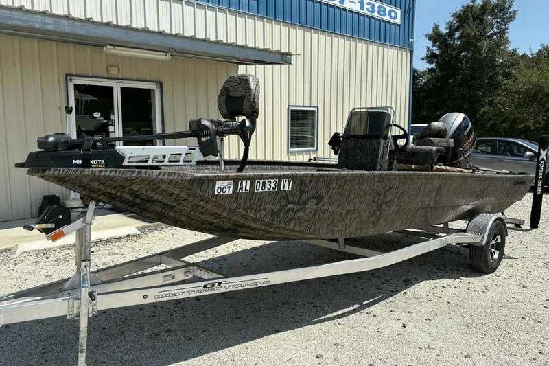 Slide: The Image of 2024 Xpress XP200 Catfish boat on trailer outside a building. - 4