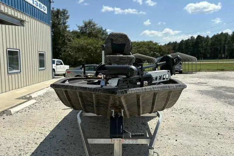 Slide: The Image of 2024 Xpress XP200 Catfish boat on trailer, parked outdoors under a clear sky. - 5