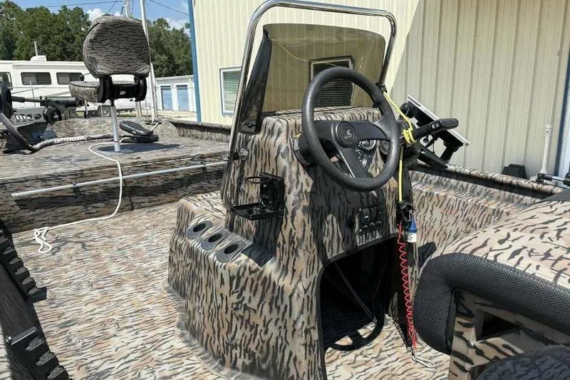 Slide: The Image of 2024 Xpress XP200 Catfish boat with camo design and steering console. - 8
