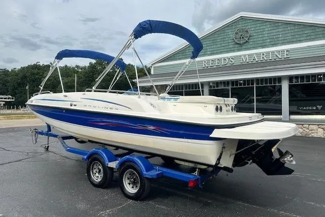 The Image of 2006 Bayliner 217 Deck Boat on trailer at Reeds Marine dealership. - 1