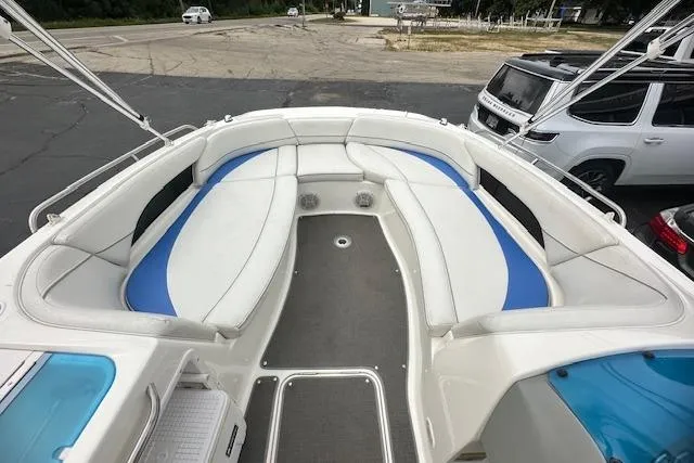 Slide: The Image of 2006 Bayliner 217 Deck Boat interior with white and blue seating. - 12