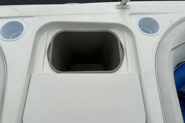 Slide: The Image of 2006 Bayliner 217 Deck Boat interior with cup holders and storage compartment. - 17