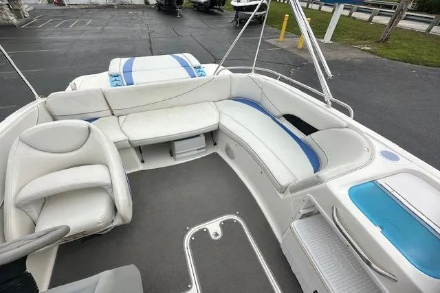 Slide: The Image of 2006 Bayliner 217 Deck Boat interior with white seating and blue accents. - 18