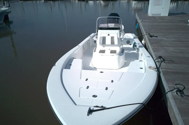Slide: The Image of 2024 BlackJack 224 boat docked, showcasing sleek design and spacious deck. - 11