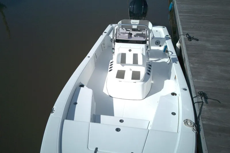 Slide: The Image of 2024 BlackJack 224 boat docked, showcasing sleek design and spacious deck layout. - 12