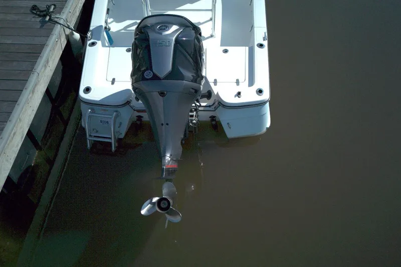 Slide: The Image of Overhead view of 2024 BlackJack 224 boat docked with powerful outboard motor. - 13