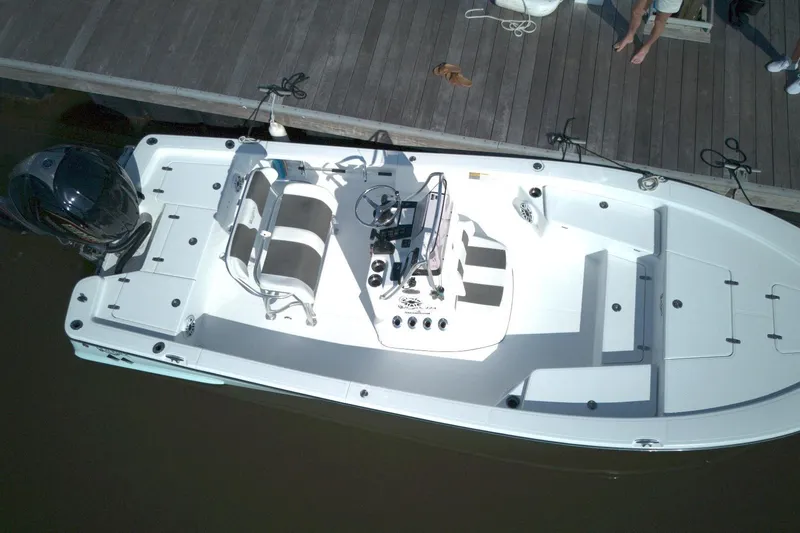 Slide: The Image of 2024 BlackJack 224 boat docked, featuring sleek design and modern outboard motor. - 2