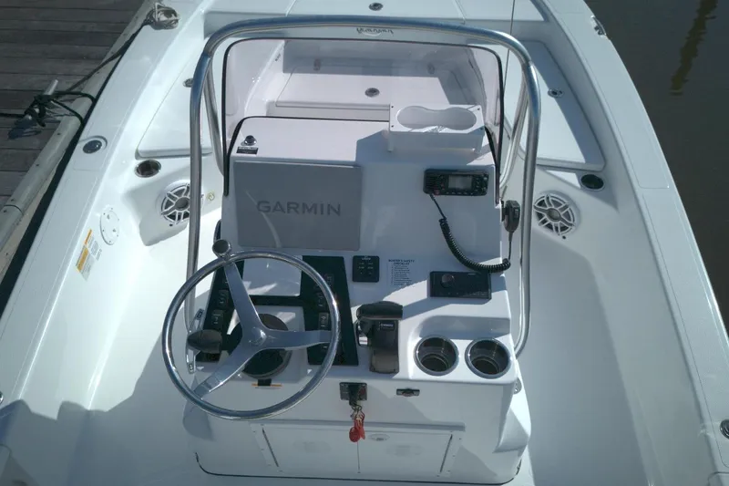 Slide: The Image of 2024 BlackJack 224 boat console with Garmin navigation and steering wheel. - 5