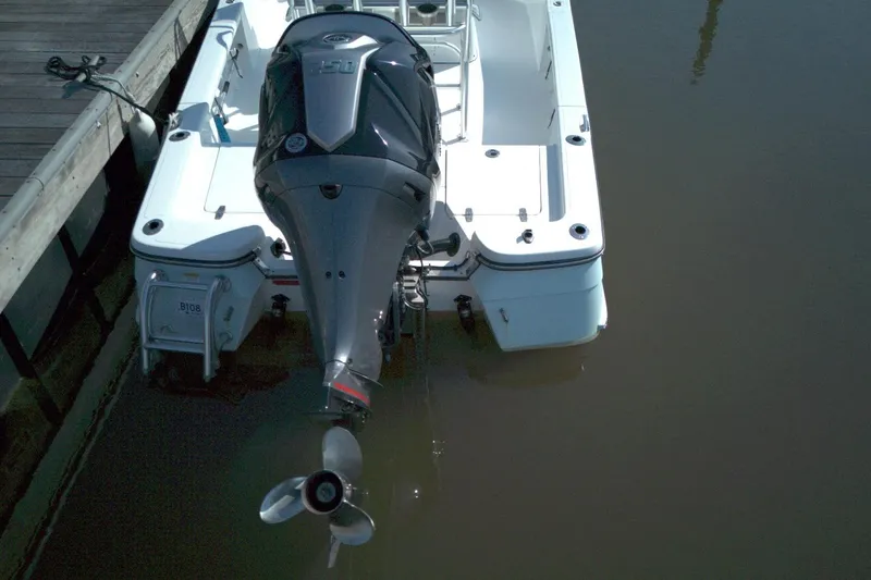Slide: The Image of 2024 BlackJack 224 boat docked, featuring a powerful outboard motor. - 6