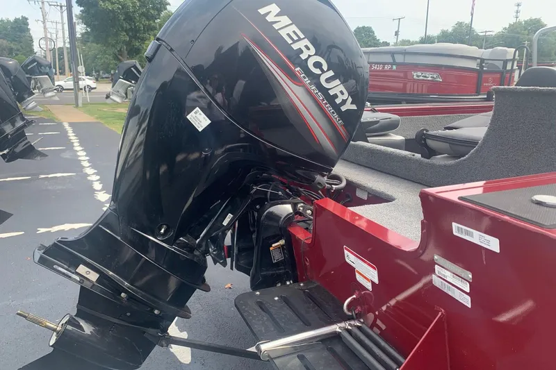 Slide: The Image of 2018 Tracker Targa V-18 Combo with Mercury FourStroke outboard motor, parked outdoors. - 2