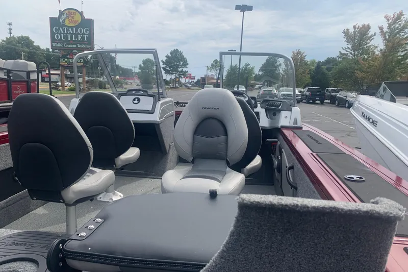 Slide: The Image of 2018 Tracker Targa V-18 Combo boat interior with seating, parked near Bass Pro Shops. - 4