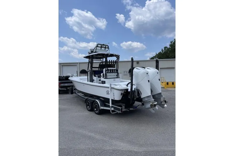 Slide: The Image of 2024 Blazer Bay 2700 Hybrid Bay boat with dual engines on a trailer. - 10