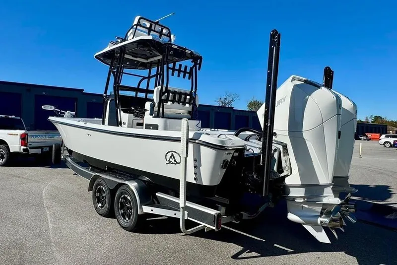 Slide: The Image of 2024 Blazer Bay 2700 Hybrid Bay boat on trailer, featuring dual outboard engines. - 3