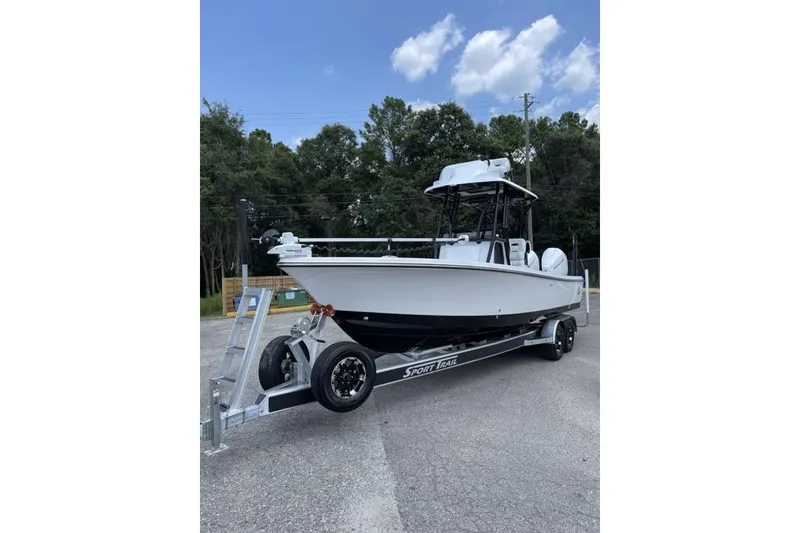 Slide: The Image of 2024 Blazer Bay 2700 Hybrid Bay boat on trailer, parked outdoors. - 9