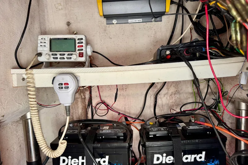 Slide: The Image of Boat electronics setup with radio, DieHard batteries, and wiring in a 2004 Pathfinder 2200-V. - 11