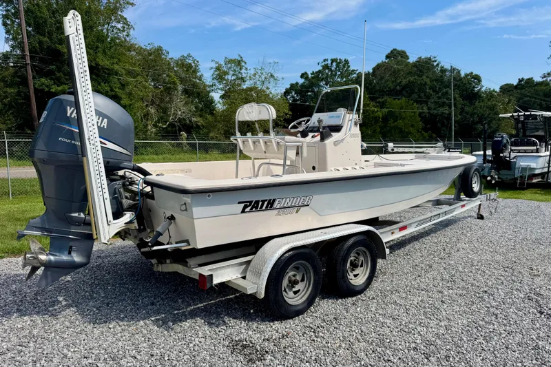 Slide: The Image of 2004 Pathfinder 2200-V boat on trailer with Yamaha outboard motor, parked on gravel. - 3