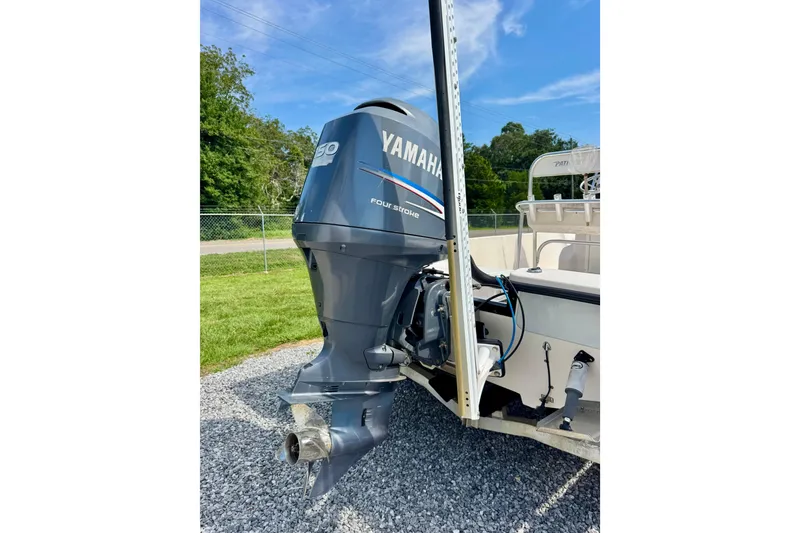 Slide: The Image of 2004 Pathfinder 2200-V boat with Yamaha outboard motor, parked on gravel. - 4