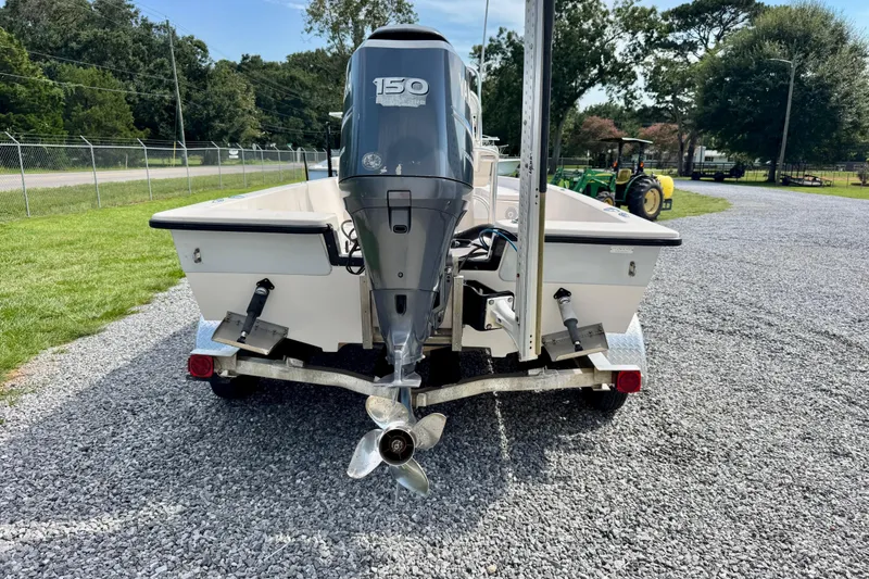 Slide: The Image of 2004 Pathfinder 2200-V boat with 150 HP outboard motor on gravel driveway. - 5