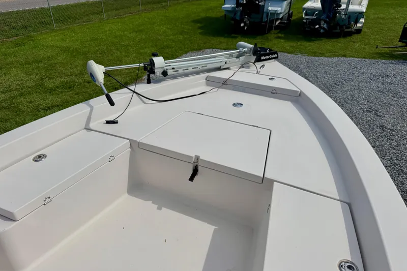 Slide: The Image of 2004 Pathfinder 2200-V boat deck with trolling motor, parked on grass and gravel. - 6