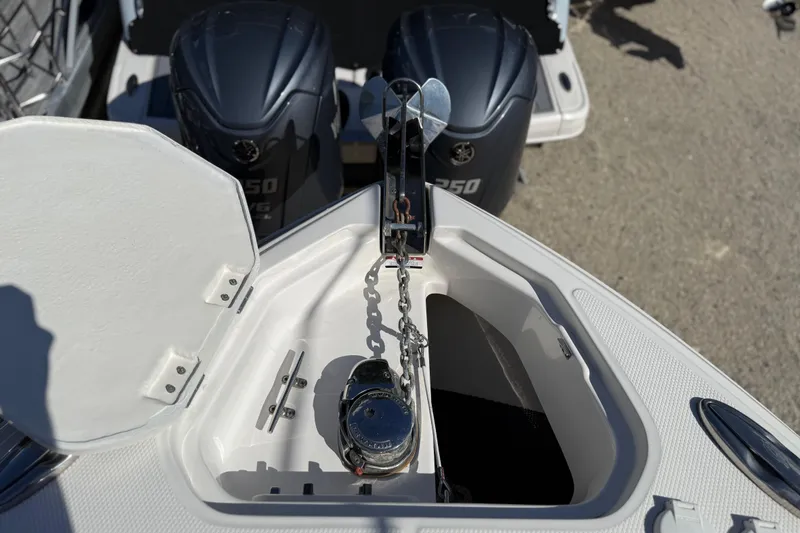 Slide: The Image of 2016 Chaparral 307 SSX boat anchor compartment with dual outboard motors. - 11