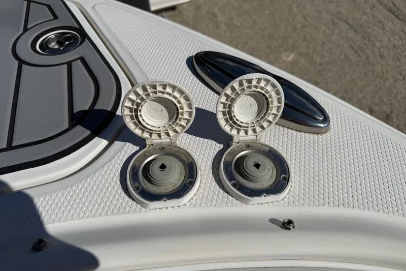 Slide: The Image of 2016 Chaparral 307 SSX boat deck with open fuel caps and textured surface. - 12