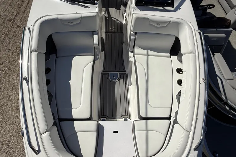 Slide: The Image of 2016 Chaparral 307 SSX boat interior with white seating and sleek design. - 14