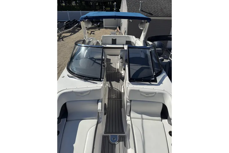 Slide: The Image of 2016 Chaparral 307 SSX boat with blue canopy and sleek interior design. - 15