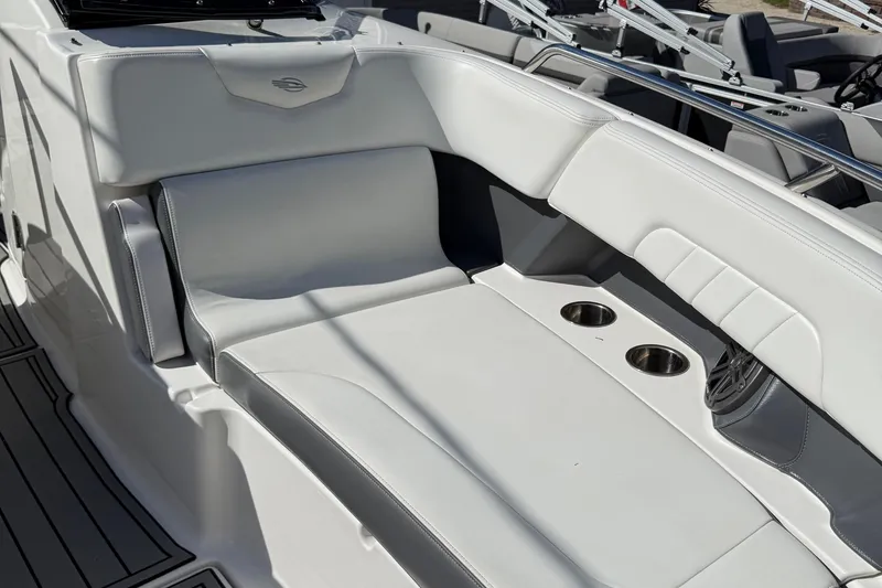 Slide: The Image of 2016 Chaparral 307 SSX boat interior with white seating and cup holders. - 18