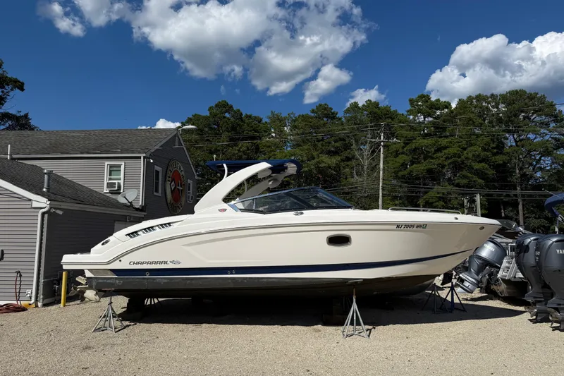 Slide: The Image of 2016 Chaparral 307 SSX boat on display outdoors under a clear blue sky. - 2