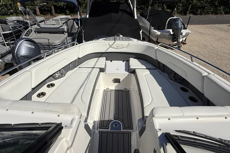 Slide: The Image of 2016 Chaparral 307 SSX boat interior with white seating and cup holders. - 21
