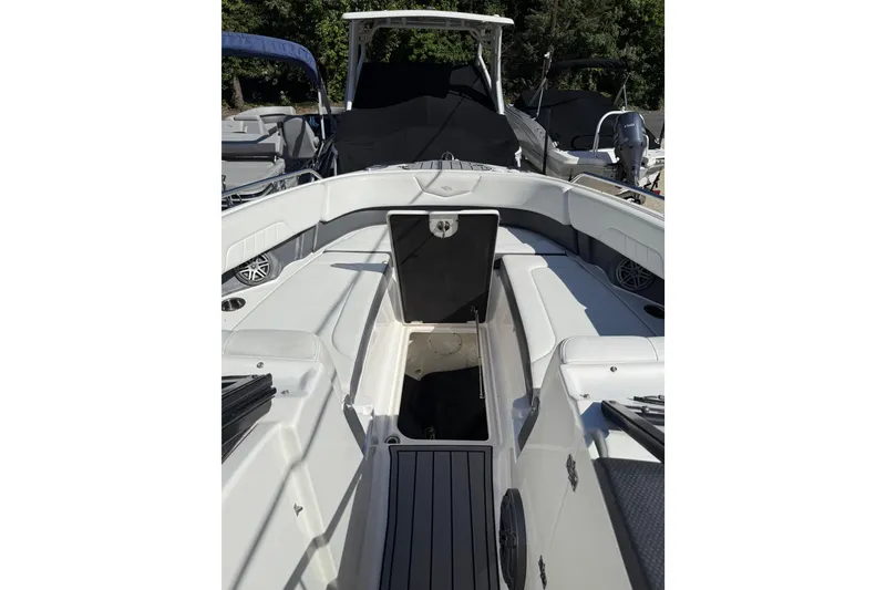 Slide: The Image of 2016 Chaparral 307 SSX boat interior with open storage compartment, white seating, and sleek design. - 22