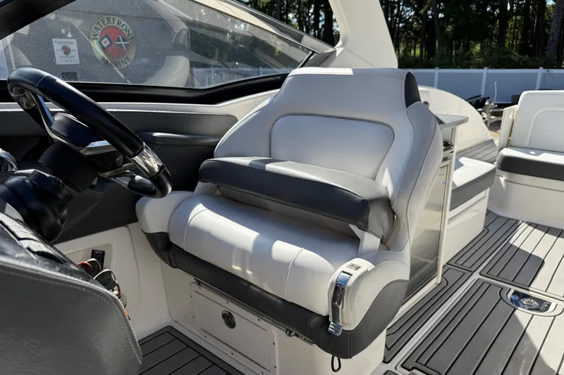 Slide: The Image of 2016 Chaparral 307 SSX boat interior with steering wheel and luxurious seating. - 24