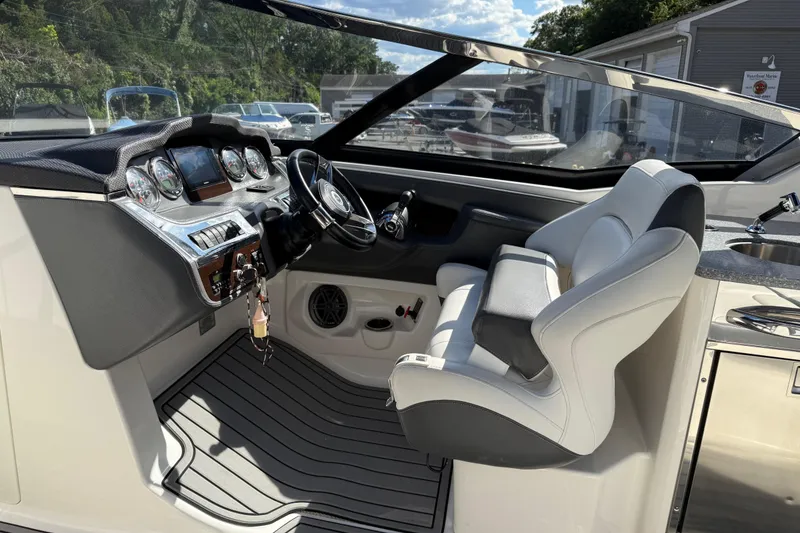 Slide: The Image of 2016 Chaparral 307 SSX boat cockpit with modern dashboard and comfortable seating. - 26