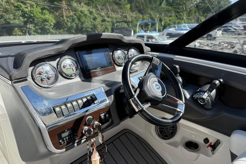 Slide: The Image of 2016 Chaparral 307 SSX boat dashboard with steering wheel and control panel. - 27