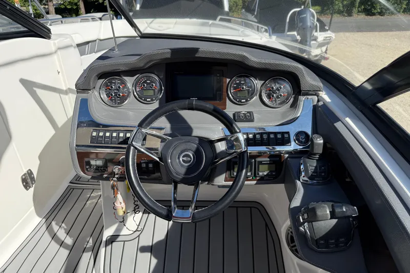 Slide: The Image of 2016 Chaparral 307 SSX boat dashboard with steering wheel and control panel. - 28