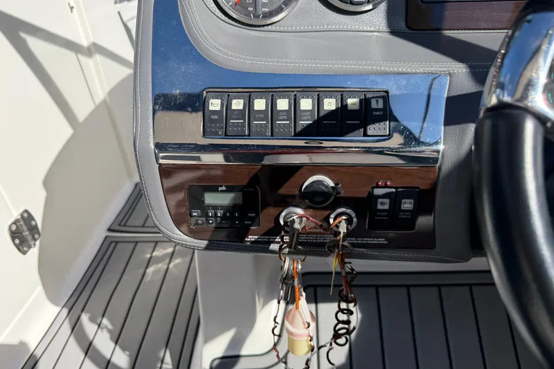 Slide: The Image of Control panel of a 2016 Chaparral 307 SSX boat with switches and keys. - 29