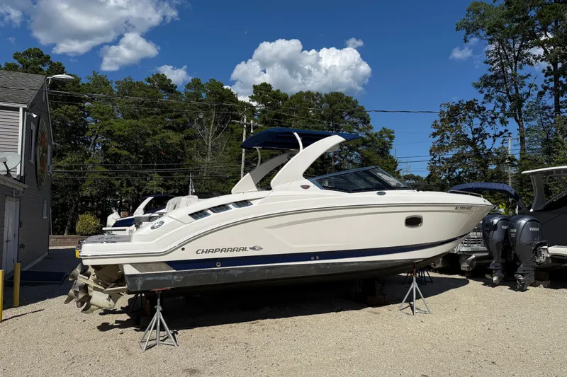 Slide: The Image of 2016 Chaparral 307 SSX boat on stands, outdoors under blue sky. - 3