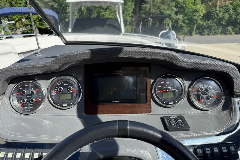 Slide: The Image of Dashboard of 2016 Chaparral 307 SSX boat with gauges and Garmin display. - 30