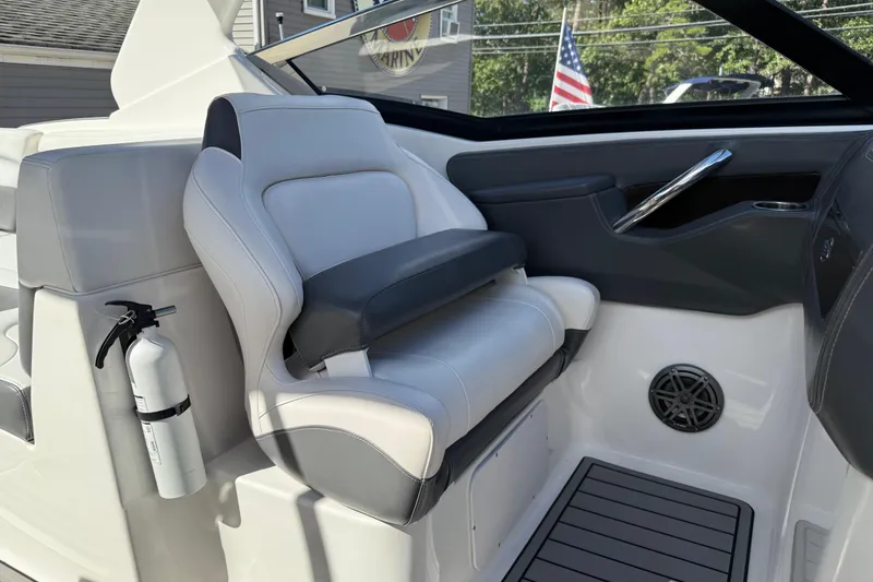 Slide: The Image of 2016 Chaparral 307 SSX boat interior with luxury seating and fire extinguisher. - 36