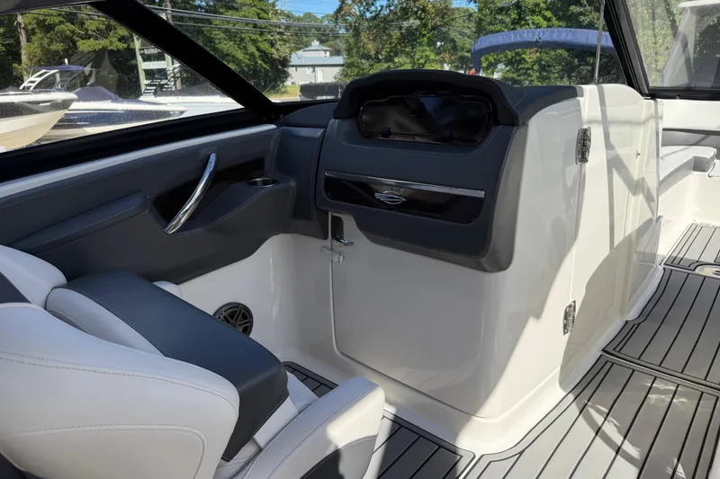 Slide: The Image of Interior of 2016 Chaparral 307 SSX boat, featuring sleek seating and modern dashboard. - 37