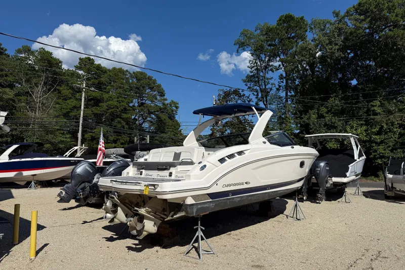 Slide: The Image of 2016 Chaparral 307 SSX boat on stands, surrounded by trees and other boats. - 4