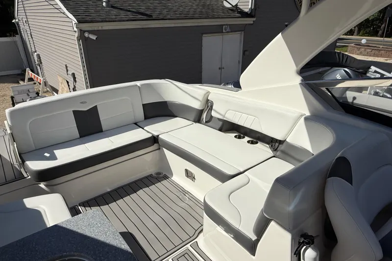 Slide: The Image of 2016 Chaparral 307 SSX boat interior with white and gray seating. - 40